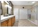 Bathroom with double sink vanity, a shower, and ample storage at 15501 W Las Verdes Way, Surprise, AZ 85374