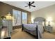 Cozy bedroom features neutral tones, shuttered windows, and a ceiling fan at 15501 W Las Verdes Way, Surprise, AZ 85374