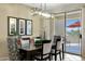 Bright dining room with modern chandelier and sliding glass doors to a patio at 15501 W Las Verdes Way, Surprise, AZ 85374