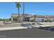 Inviting desert home featuring a tile roof, desert landscaping, palm trees, and a well-maintained lawn at 15501 W Las Verdes Way, Surprise, AZ 85374