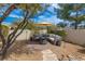 Relaxing backyard patio featuring an umbrella-covered seating area, a fire pit, and desert landscaping at 15803 E Tumbleweed Dr, Fountain Hills, AZ 85268