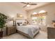 A well-lit bedroom with arched windows, ceiling fan and stylish decor at 15803 E Tumbleweed Dr, Fountain Hills, AZ 85268