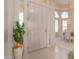 Bright foyer with tile floors, a decorative plant, and a view of the formal dining area through an arched doorway at 15803 E Tumbleweed Dr, Fountain Hills, AZ 85268