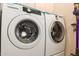 This laundry room includes a stacked washer and dryer and modern finishes at 15803 E Tumbleweed Dr, Fountain Hills, AZ 85268