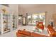 Bright living room featuring a seating area, display shelving, and sliding glass doors leading to the backyard at 15803 E Tumbleweed Dr, Fountain Hills, AZ 85268