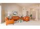 Bright living room with orange sofas, high ceilings, and decorative lighting fixture at 15803 E Tumbleweed Dr, Fountain Hills, AZ 85268