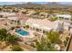 Back aerial showing a pool, hot tub, desert landscaping, covered patio, and mountain views in the background at 15803 E Tumbleweed Dr, Fountain Hills, AZ 85268