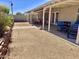 Spacious backyard featuring a covered patio, gravel, block wall, and seating area at 16243 N 27Th St, Phoenix, AZ 85032