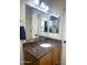 Bathroom with granite countertop, white basin sink, and a large mirror showcasing a neutral wall color at 16243 N 27Th St, Phoenix, AZ 85032