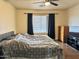 Bedroom with a large window, neutral walls, dark curtains, and wooden dresser at 16243 N 27Th St, Phoenix, AZ 85032