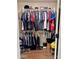 Walk-in closet with double-hang shelving, lots of clothing, shoes and accessories at 16243 N 27Th St, Phoenix, AZ 85032