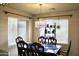 Dining area featuring wooden table, chairs, decorative chandelier, and window with blinds at 16243 N 27Th St, Phoenix, AZ 85032