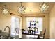 Dining area features starburst pendant lighting, decorative window, and wood dining set at 16243 N 27Th St, Phoenix, AZ 85032