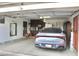 Spacious two-car garage with cabinets and refrigerator, housing a sleek, grey Kia sedan at 16243 N 27Th St, Phoenix, AZ 85032