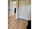 Hallway features wood flooring, multiple doors, and access to various rooms at 16243 N 27Th St, Phoenix, AZ 85032