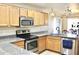 Kitchen featuring granite counters, stainless steel appliances, sink and wooden cabinets at 16243 N 27Th St, Phoenix, AZ 85032