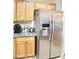 Stainless steel fridge and wooden cabinets in a brightly lit kitchen at 16243 N 27Th St, Phoenix, AZ 85032