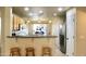 Well-lit kitchen with stainless steel appliances, granite countertops, and seating at the breakfast bar at 16243 N 27Th St, Phoenix, AZ 85032