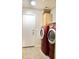 Spacious laundry room featuring vibrant red washer and dryer units and ample storage options at 16243 N 27Th St, Phoenix, AZ 85032