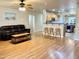 Open-concept living room with wood floors and barstool seating overlooking the kitchen at 16243 N 27Th St, Phoenix, AZ 85032