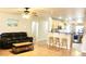 Open-concept living room with wood floors and barstool seating overlooking the kitchen at 16243 N 27Th St, Phoenix, AZ 85032