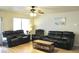 Inviting living room featuring wood floors, a ceiling fan and comfortable seating at 16243 N 27Th St, Phoenix, AZ 85032