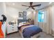 This secondary bedroom features neutral walls, a ceiling fan, and a window for natural light at 17162 W Corrine Dr, Surprise, AZ 85388