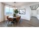 Dining room with elegant lighting, hardwood floors, and large window at 17162 W Corrine Dr, Surprise, AZ 85388