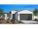 Charming single-story home with a gray garage door, tiled roof, desert landscaping, and a private entrance at 17162 W Corrine Dr, Surprise, AZ 85388