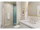 Modern bathroom with a walk-in shower, a vessel sink, and a sleek vanity with a white countertop at 17505 N 96Th Way, Scottsdale, AZ 85255