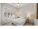 Cozy bedroom with neutral tones, plantation shutters, and comfortable furnishings for a relaxing retreat at 17505 N 96Th Way, Scottsdale, AZ 85255