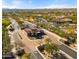 Aerial view of a beautifully landscaped community entrance with tree-lined streets and sidewalks at 17505 N 96Th Way, Scottsdale, AZ 85255