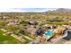 Overhead shot of a community pool area with multiple pools, shaded lounging spaces, and verdant landscaping, promoting a resort-style living at 17505 N 96Th Way, Scottsdale, AZ 85255