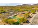 Scenic community playground with a basketball court, covered picnic area, and various play structures, all surrounded by lush greenery at 17505 N 96Th Way, Scottsdale, AZ 85255