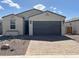 Charming single-story home with a paved driveway and two-car garage at 18105 W Hiddenview Dr, Goodyear, AZ 85338