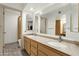 Bathroom featuring double sinks and oak cabinets with a large mirror and ceramic tile flooring at 18833 E Latigo Ln, Rio Verde, AZ 85263