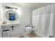 Clean, well-lit bathroom featuring white subway tile, a round mirror and low flow toilet at 18833 E Latigo Ln, Rio Verde, AZ 85263