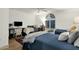 Bright bedroom featuring three twin beds, work desk, and a fan, all illuminated by natural light at 18833 E Latigo Ln, Rio Verde, AZ 85263