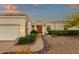 Inviting front entrance features desert landscaping, and a covered porch with decorative columns at 18833 E Latigo Ln, Rio Verde, AZ 85263