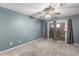 Bedroom featuring soft gray carpet, sliding glass door to the back patio and neutral paint at 20421 N 3Rd Dr # 2, Phoenix, AZ 85027