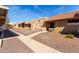 Exterior view of a row of homes with desert landscaping and a blue sky at 20421 N 3Rd Dr # 2, Phoenix, AZ 85027