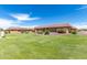 Exterior view of the home showcasing the well-maintained green lawn and landscaping at 20421 N 3Rd Dr # 2, Phoenix, AZ 85027