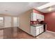 Combined living space featuring white cabinets, wood floors, and an open layout at 20421 N 3Rd Dr # 2, Phoenix, AZ 85027