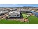 An aerial view of a home in a community with a lake and mountain views at 20745 N Verbena Ln, Maricopa, AZ 85138