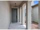Covered front entryway with decorative columns, a tiled floor, and a stylish pendant light fixture above the front door at 20745 N Verbena Ln, Maricopa, AZ 85138