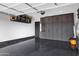 View of the garage with epoxy floor, and built in storage cabinets, and overhead storage at 20745 N Verbena Ln, Maricopa, AZ 85138