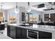 Kitchen island with stainless steel dishwasher and oven offering lots of natural light at 20745 N Verbena Ln, Maricopa, AZ 85138