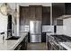 Well-appointed kitchen featuring stainless steel appliances, marble counters, and dark wood cabinets at 20745 N Verbena Ln, Maricopa, AZ 85138