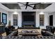 Cozy living room featuring a modern fireplace, sleek decor, and comfortable seating at 20745 N Verbena Ln, Maricopa, AZ 85138