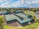 Aerial view of multiple pickleball courts, mature landscaping, and community buildings at 20745 N Verbena Ln, Maricopa, AZ 85138